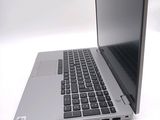 a silver laptop with a black keyboard on a white surface