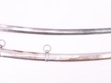 two swords on a white surface one has a black handle and the other has a brown handle