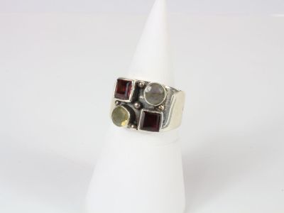 a close up of a ring on a white cone on a white surface