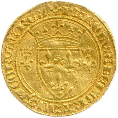 a close up of a gold coin on a white surface