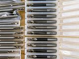 a close up of a box filled with lots of pens and pencils
