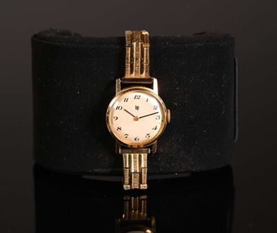 an image of a gold wrist watch with roman numerals on a black surface