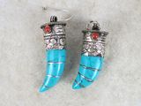 a pair of turquoise and silver earrings with red stones