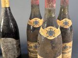 several bottles of wine are lined up on a table
