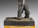 sculpture of a woman ' s legs on a marble base