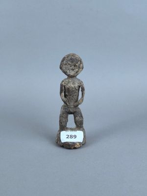 figurine représentant un homme debout sur un rocher, tenant une pancarte à la main