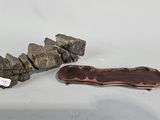 two pieces of wood sit next to a rock on a table