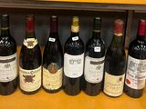 plusieurs bouteilles de vin sont alignées sur une étagère dans un magasin