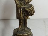 pair of antique brass figurines of a man holding a drum