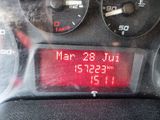 a close up of a digital clock on a car ' s dashboard