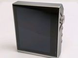 a small digital camera sitting on a white surface
