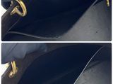 a picture of a black purse with a gold handle