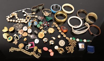 many different types of jewelry on a black table