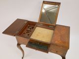 a small wooden table with a mirror on top of it