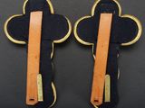 pair of black and tan leather hair clips with gold accents