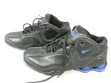 pair of black and blue sneakers with laces on them on a white surface