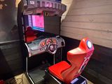 a video game machine with a steering wheel and a video game console
