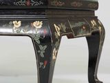 a black table with a floral design on it