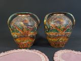 two vases sitting next to each other on a table