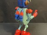 a toy robot that is standing on a table
