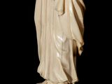 an antique statue of a man in a robe and hat