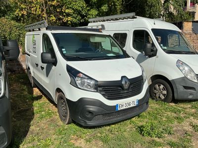 two white vans parked next to each other in the grass