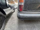 two cars parked on the side of the road next to each other