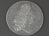 a close up of a silver coin with a woman ' s head on it