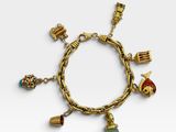 a gold bracelet with charms and charms on it