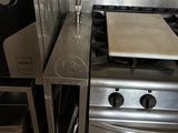 a stainless steel stove and oven in a small kitchen