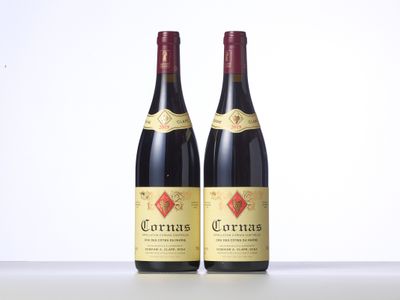 two bottles of red wine sitting on top of a table