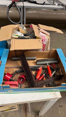 a box of tools sitting on a table with a pair of scissors