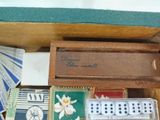 a wooden box with dice and cards in it