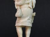 statue of a woman carrying a child on her back