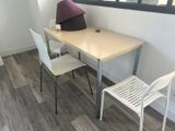 a table with two chairs and a lamp on top of it