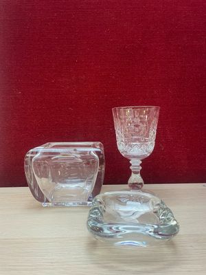 a small glass cup and a small glass bowl on a table