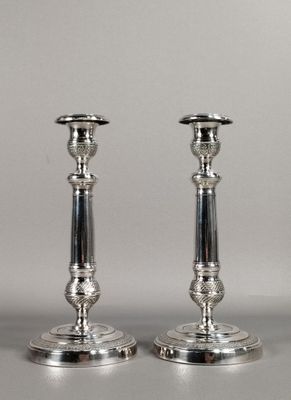 une paire de chandeliers en argent sur fond blanc