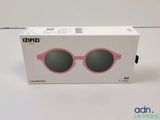 a box with a pair of pink sunglasses inside of it