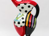 a red vase with a polka dot design on it
