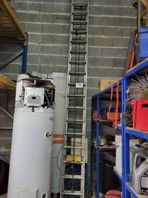a picture of a room with a ladder and a water heater