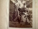 an old photo of a man and a woman sitting in a field