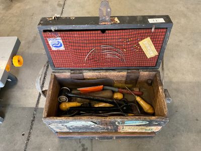 a box with tools in it sitting on the floor