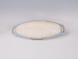 a blue and white plate with a handle on it