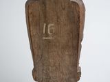 wooden sculpture of a bird on a stand with numbers carved into it