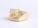 an image of a gold signet ring on a white surface
