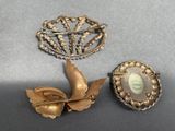 two brooches and a brooch are sitting on a table