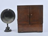 a small wooden cabinet with a speaker on it