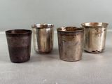 three silver cups sitting on a table next to each other