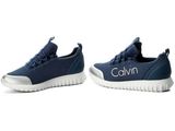 the children ' s shoes are blue and white with the name calvin on them