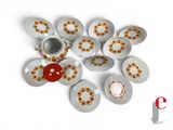 a lot of plates and cups on a white surface